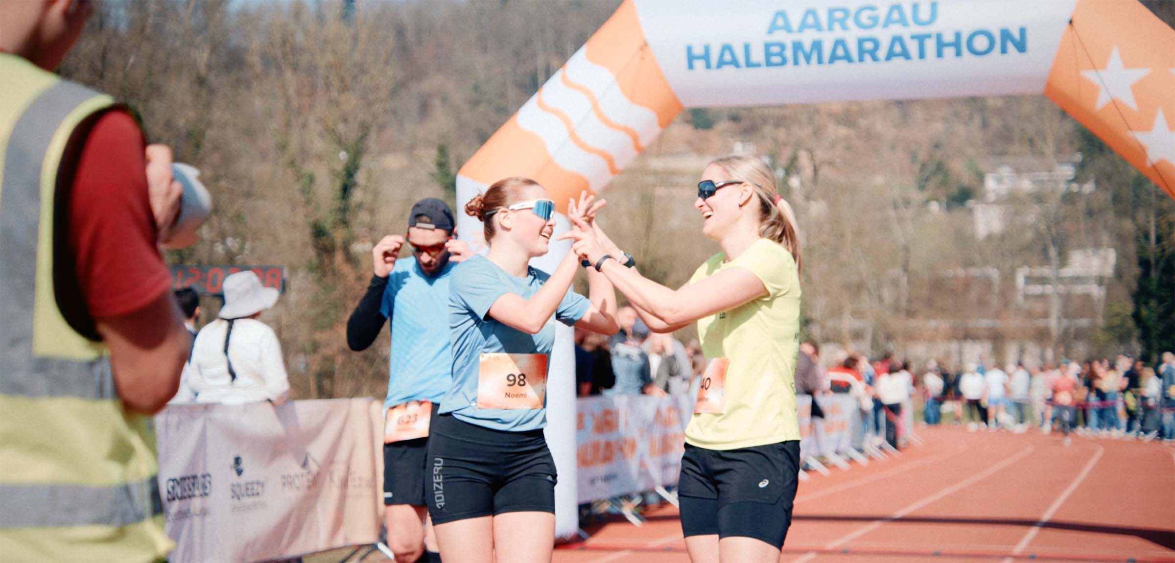 female runners at finish line celebrating